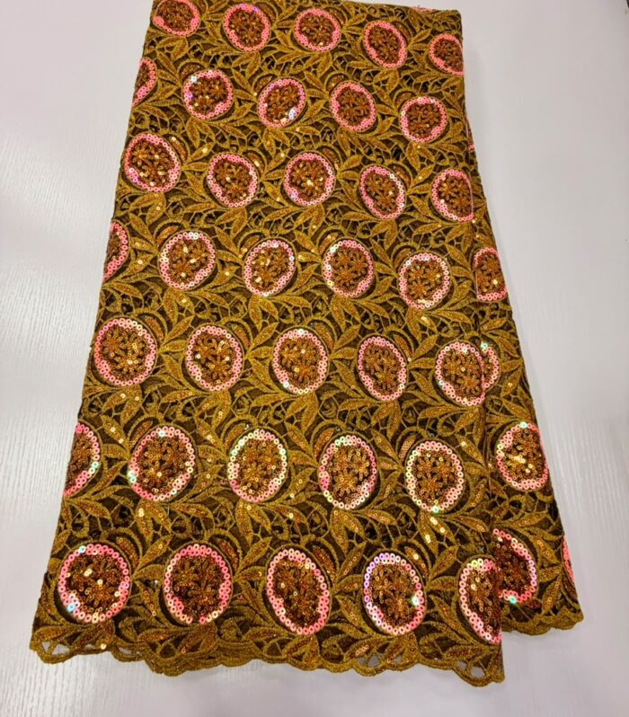 Elevate your occasion wear with this premium gold Net Lace fabric. Designed with an intricate floral and leaf mesh base, it features repeating circular motifs framed in vibrant pink sequins and filled with reflective gold sequins. The scalloped borders provide a clean finish for tailored hems and sleeves.