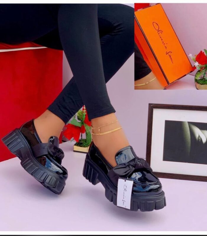 Shop these stylish women's black patent leather chunky platform loafers featuring a cute front bow! Durable, comfortable, and trendy footwear for any occasion.
